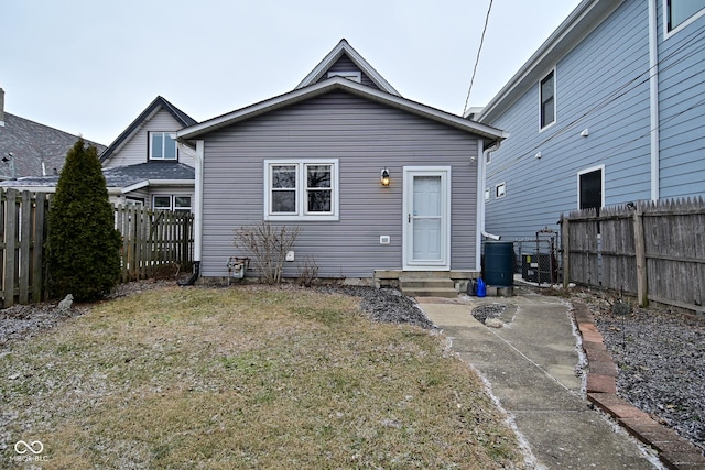 back of property with a patio and a yard