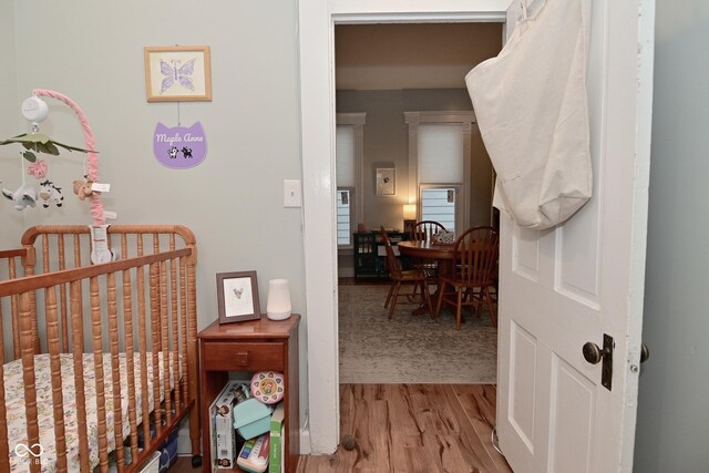 1719 Fletcher Ave, Indianapolis, IN 46203 - bedroom featuring a nursery area and light wood-type flooring