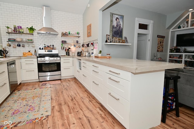 1719 Fletcher Ave, Indianapolis, IN 46203 - kitchen with wall chimney exhaust hood, white cabinetry, appliances with stainless steel finishes, and kitchen peninsula