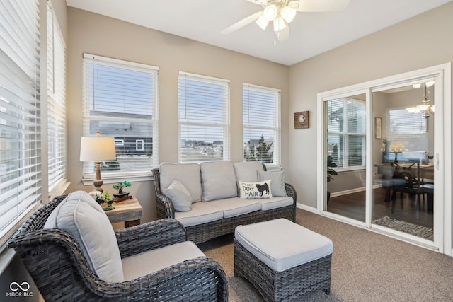 sunroom with ceiling fan with notable chandelier