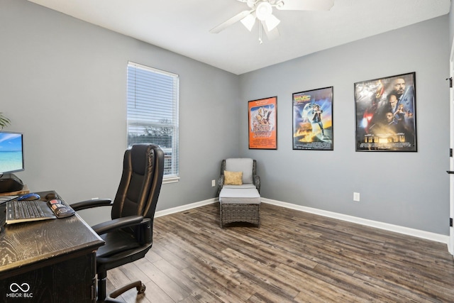 home office featuring dark wood-type flooring and ceiling fan