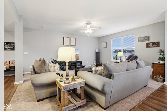 living room featuring wood-type flooring and ceiling fan