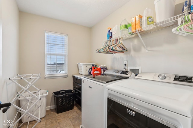 clothes washing area featuring washing machine and clothes dryer