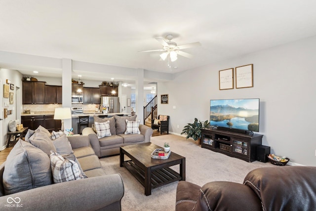 living room with light carpet and ceiling fan