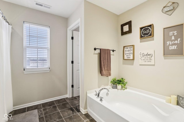 bathroom with tile patterned flooring and a bathing tub