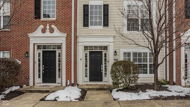 view of snow covered property entrance