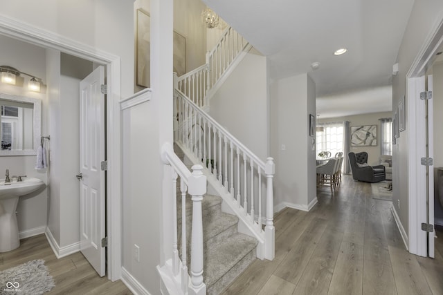 stairway with hardwood / wood-style flooring