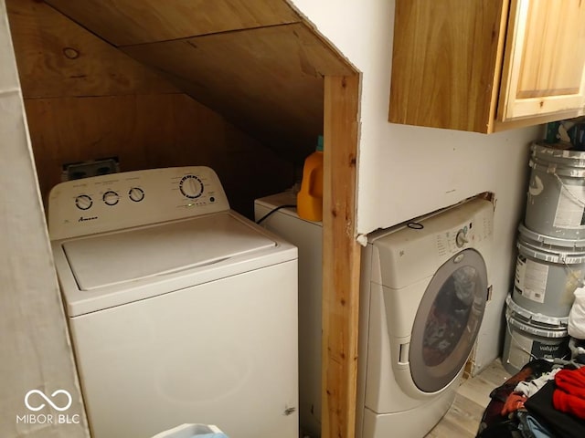 laundry area with cabinets, separate washer and dryer, and wooden ceiling