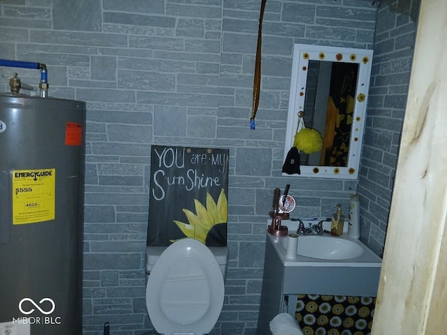 bathroom with water heater, sink, and toilet