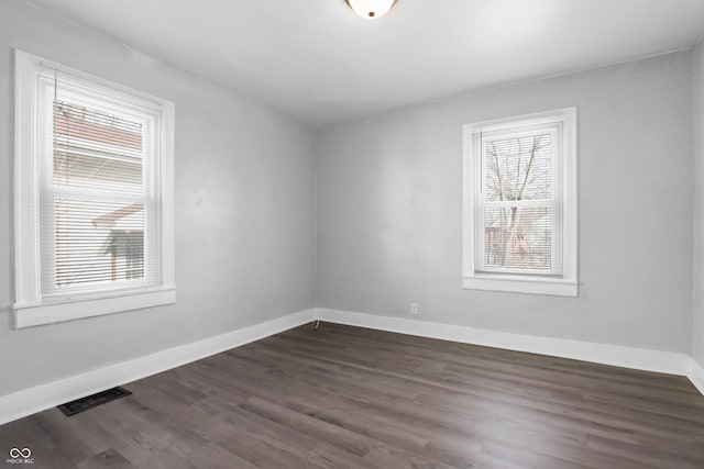 spare room with dark hardwood / wood-style floors