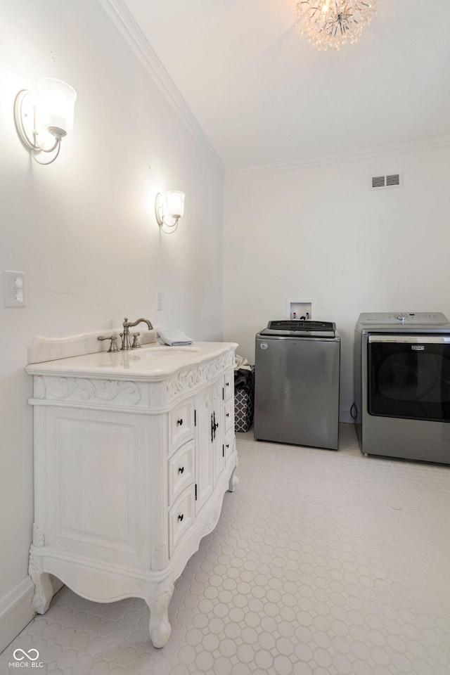 bathroom featuring ornamental molding, vanity, and independent washer and dryer