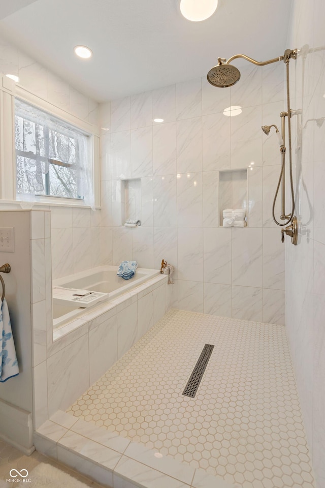 bathroom featuring tile patterned flooring and a tile shower