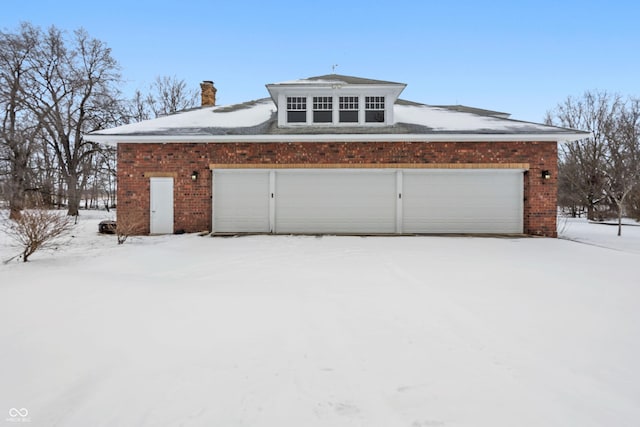 view of snow covered garage