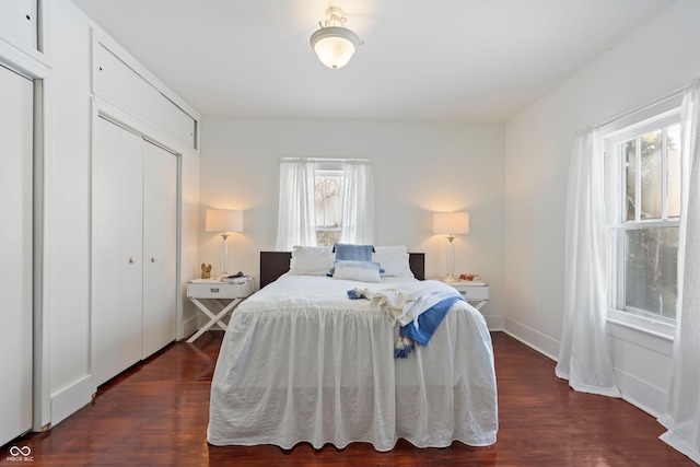 bedroom with dark hardwood / wood-style flooring and a closet