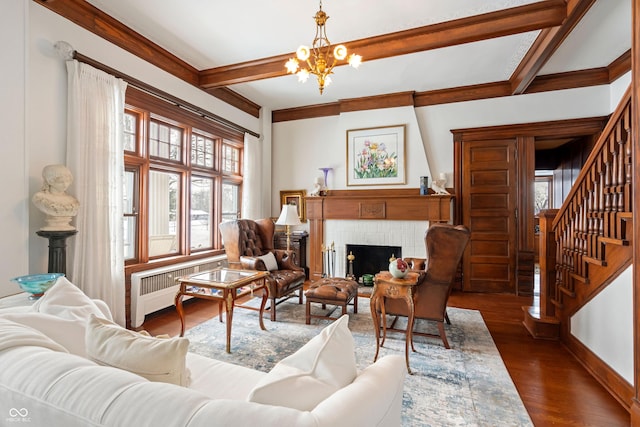 living room featuring a chandelier, radiator heating unit, dark hardwood / wood-style flooring, beamed ceiling, and a fireplace