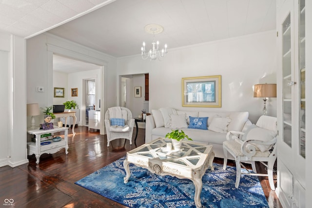 living room featuring crown molding, dark hardwood / wood-style floors, and a chandelier