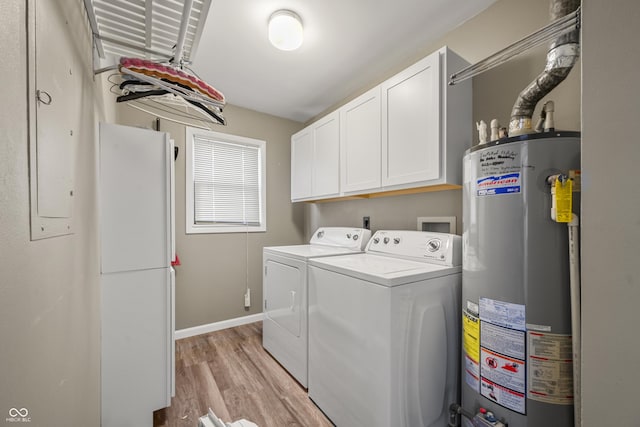 laundry room featuring washer and dryer, gas water heater, cabinets, and light hardwood / wood-style flooring