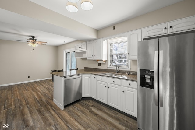 kitchen with white cabinetry, sink, dark hardwood / wood-style floors, and appliances with stainless steel finishes