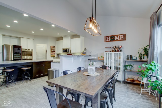 dining space with lofted ceiling