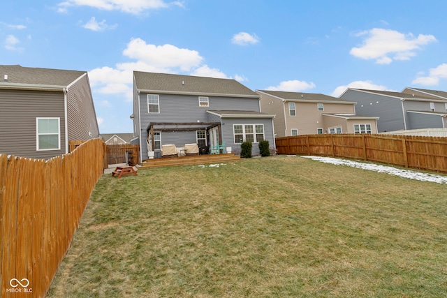 back of property featuring a yard, a pergola, and a deck