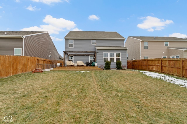 rear view of property with a pergola, a lawn, and a deck