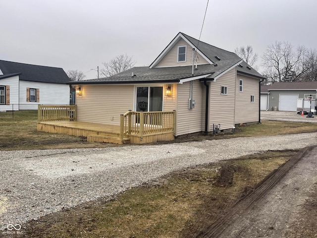 view of front of home featuring a garage and a wooden deck