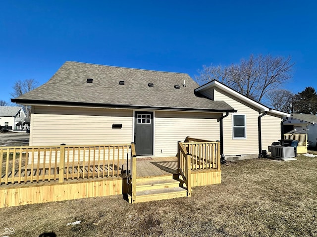 back of house featuring a wooden deck, a yard, and central AC unit