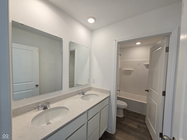 full bathroom with vanity, shower / bathing tub combination, hardwood / wood-style floors, and toilet