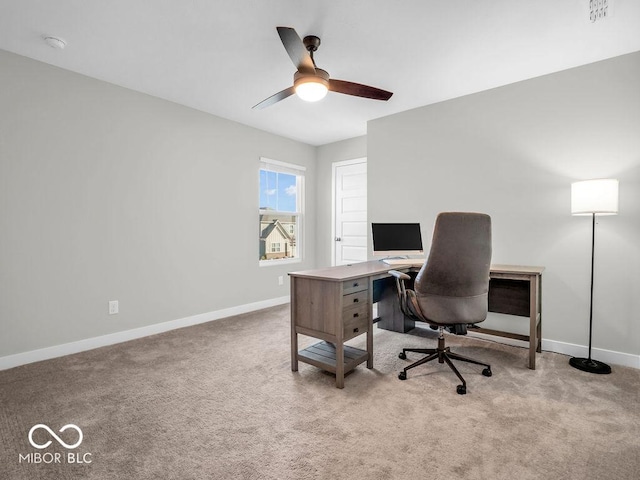 carpeted home office featuring ceiling fan