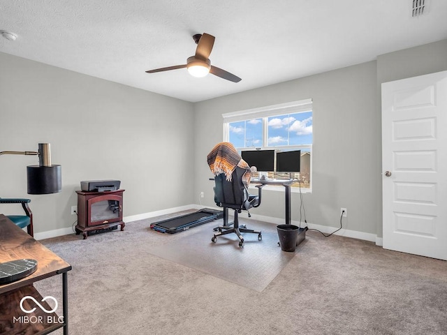 carpeted office space featuring ceiling fan