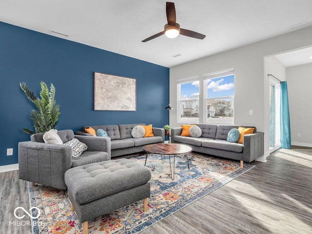 living room featuring hardwood / wood-style flooring and ceiling fan