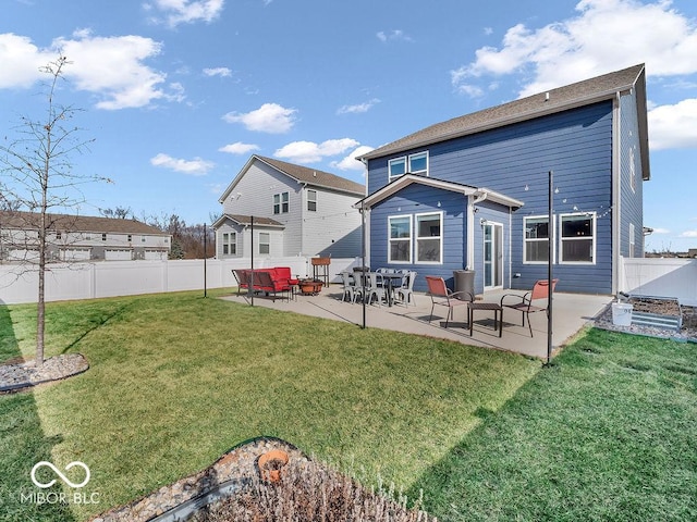 rear view of property with a yard and a patio