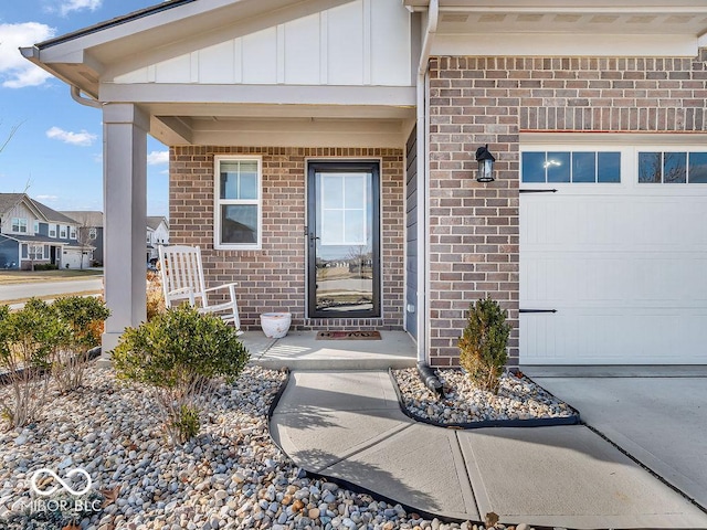 entrance to property featuring a garage and a porch