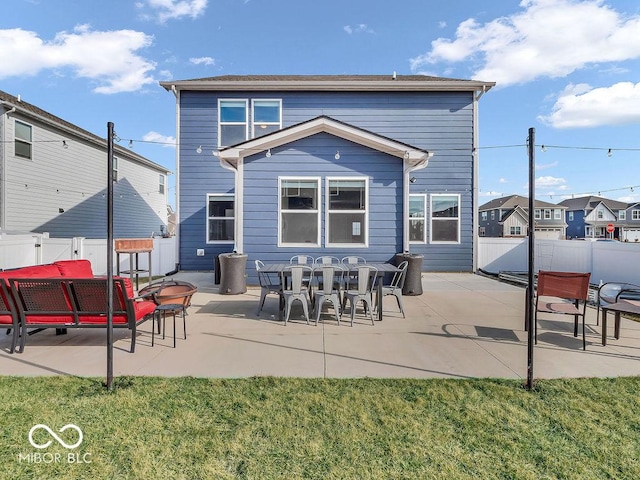 back of property featuring a patio and a yard