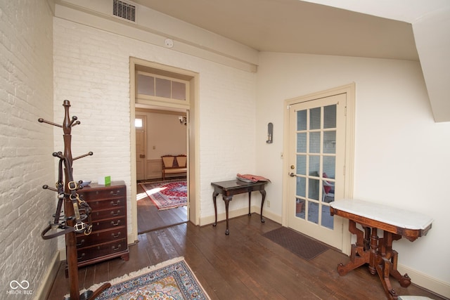 interior space with lofted ceiling and dark hardwood / wood-style floors