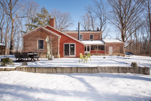 view of snow covered back of property