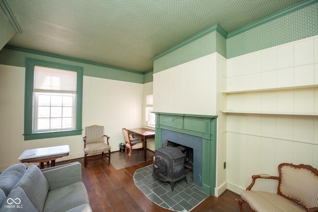 sitting room featuring a healthy amount of sunlight, ornamental molding, and dark hardwood / wood-style flooring