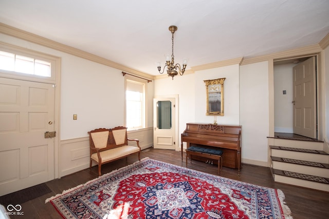 sitting room with ornamental molding, dark hardwood / wood-style flooring, and a chandelier