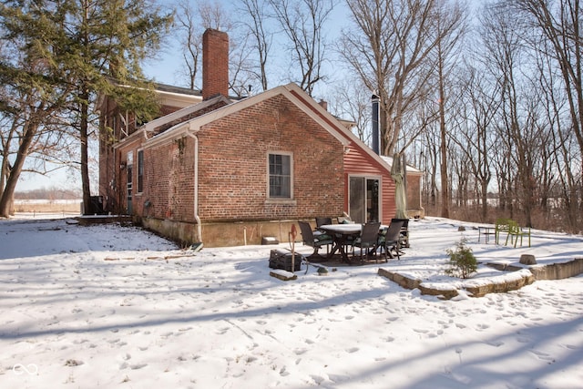 view of snow covered rear of property