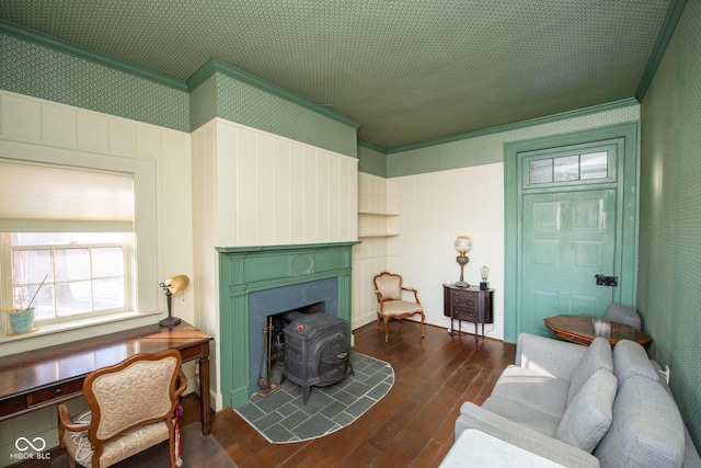 living room with crown molding, dark wood-type flooring, and a wood stove