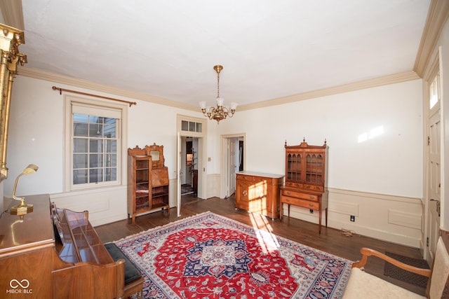 interior space featuring ornamental molding, dark wood-type flooring, and a notable chandelier