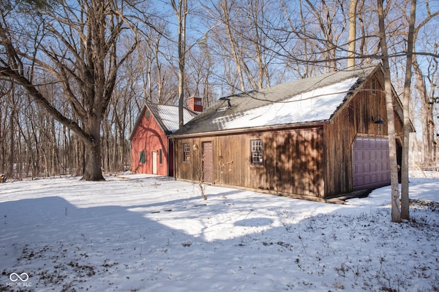 exterior space featuring a garage and an outdoor structure