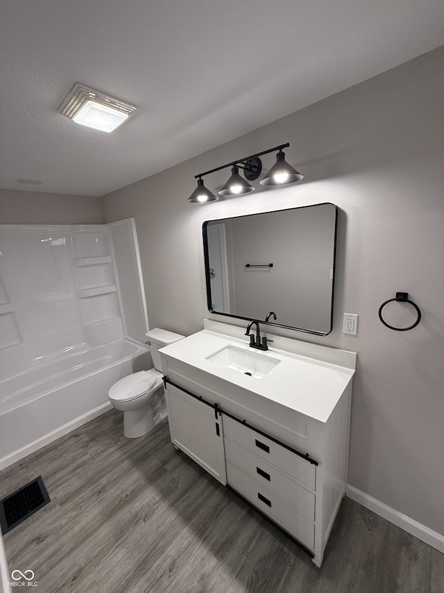 full bathroom featuring shower / tub combination, vanity, toilet, and hardwood / wood-style floors