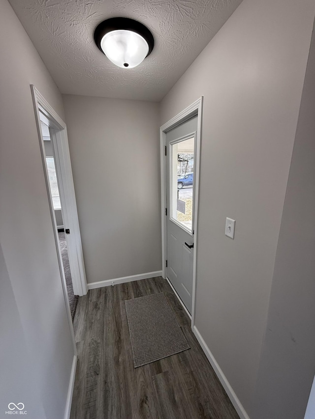 entryway with dark hardwood / wood-style flooring and a textured ceiling