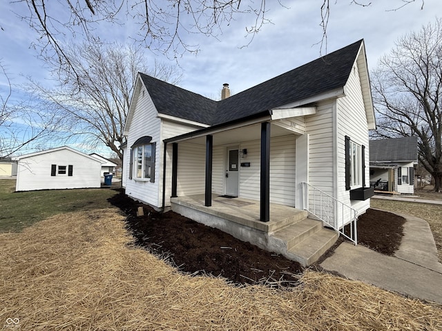 view of front of property with a porch and a front lawn