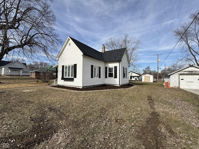 view of home's exterior featuring a storage shed, a yard, and a garage