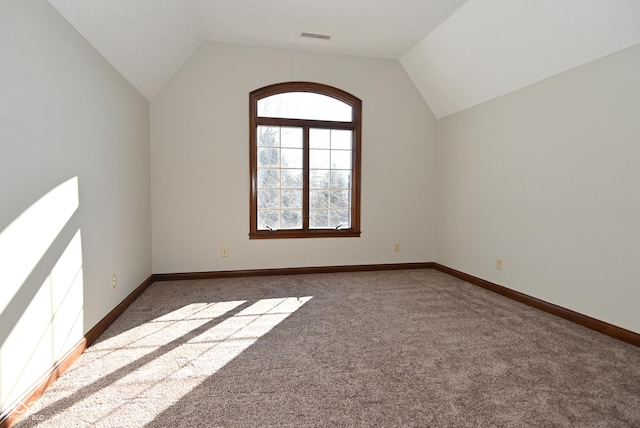 bonus room with vaulted ceiling and carpet flooring