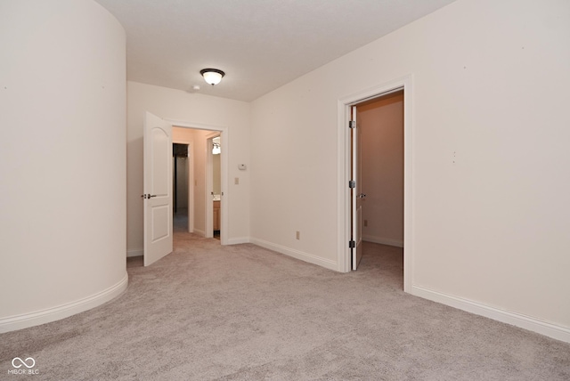 unfurnished bedroom with light colored carpet