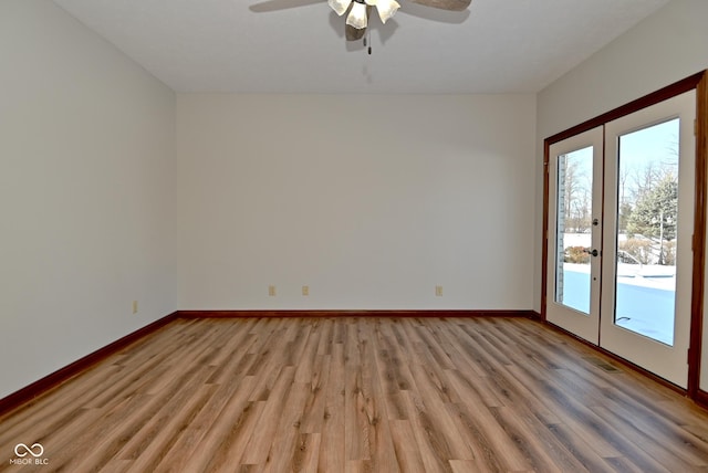 unfurnished room with light hardwood / wood-style floors, french doors, and ceiling fan