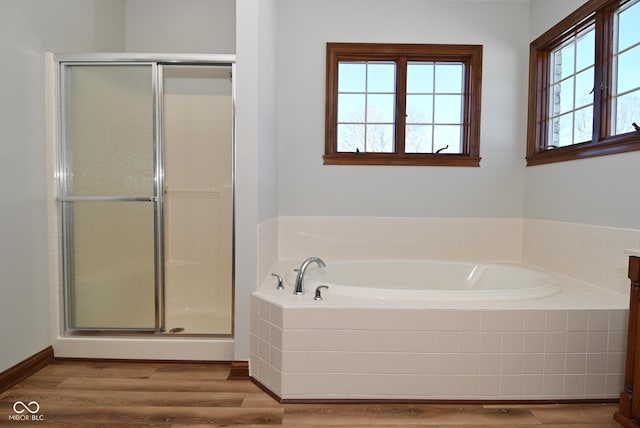 bathroom featuring wood-type flooring and plus walk in shower